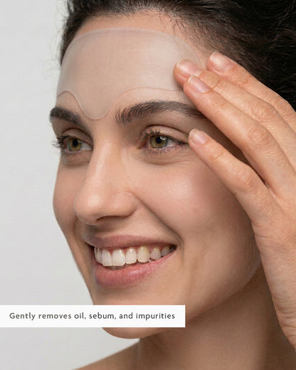 Pressing a hydrocolloid patch onto a forehead breakout