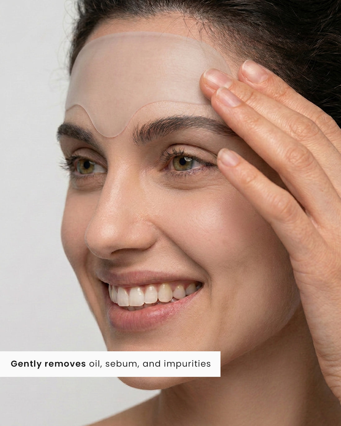 Smiling woman wearing a KYLA forehead patch that gently removes oil, sebum and impurities