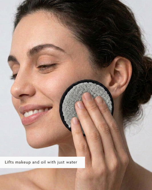 Woman using the reusable microfiber pad to lift makeup and oil with water