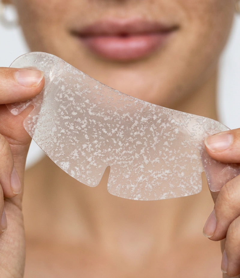 Woman holding a wide hydrocolloid patch to her face